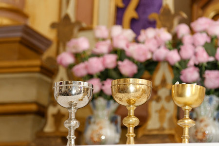 chalice and ambula on the altar, moment of the holy mass - Consecration of bread and wine in the...