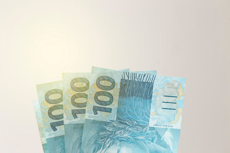money from brazil stacked on white surface - several hundred real billsの写真素材