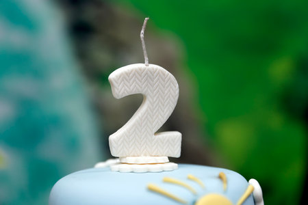 detail of the number two on the top of the birthday cake, 2nd birthday, white cake, 2 year old birthday cake candleの写真素材