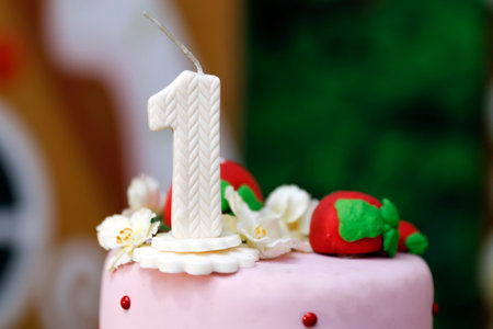 detail of the number one on the top of the birthday cake, 1st birthday, white cake, 1 year old birthday cakeの写真素材