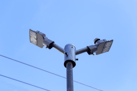 metal illuminator with cold LED technology lamps on top of a pole