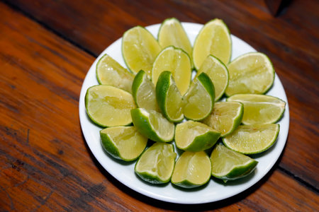 green fruit lemons cut into bowl and ready to serveの写真素材
