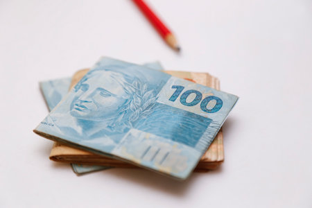 several real notes - money from Brazil on the table and a pencil