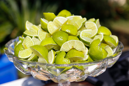 green fruit lemons cut into bowl and ready to serveの写真素材