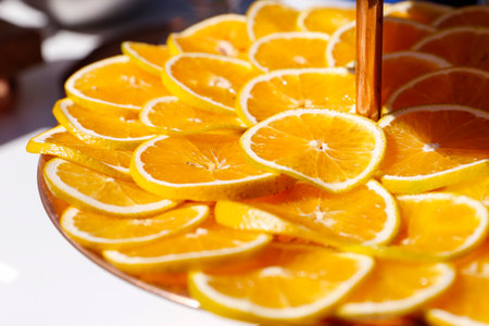oranges fruits cut into thin slices in bowlの写真素材