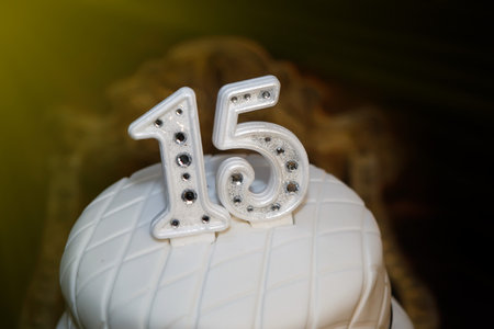 White party cake, 15th birthday, with silver number fifteen, white cake, 15 year old birthday cakeの写真素材