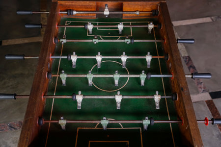 Used foosball table in a casual setting, perfect for tabletop soccer matches and fun with friends...