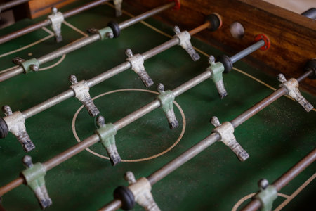 Detailed close-up of a used football table showing players, pieces, and texture, perfect for...