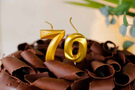 Golden birthday candle 70, traditional and elegant for sophisticated parties. Top creamy cake with...
