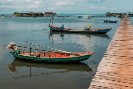 Small fishing boats near a pier in Vietnamの写真素材