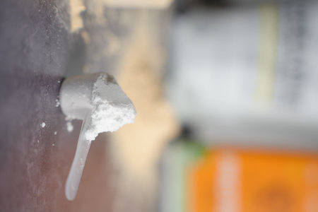 Heaped Scoop of Creatine Powder with Bag in Background. Vertical shot.の写真素材
