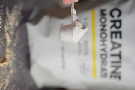 Heaped Scoop of Creatine Powder with Bag in Background. Vertical shot.の写真素材