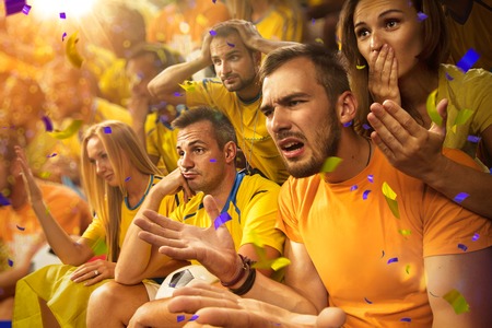 Fun soccer Fans in stadium arena Confetti and tinselの写真素材
