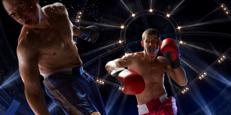 Boxer athlete in action. boxing ring. water drops and blood in faceの写真素材