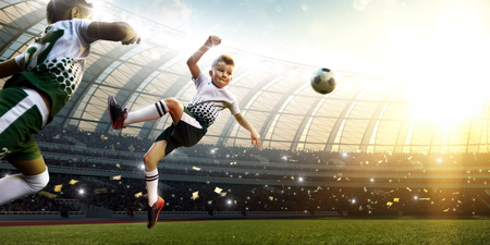 children soccer player in action in stadiumの写真素材