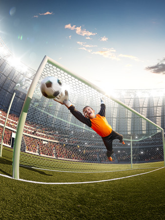 gatekeeper children soccer player in action. stadiumの写真素材