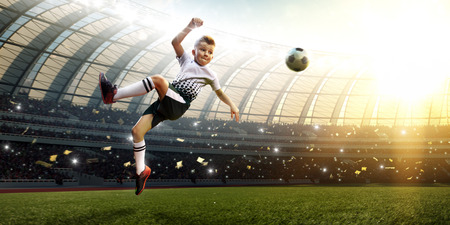 children soccer player in action in stadium soloの写真素材