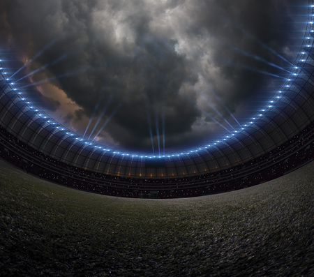Soccer stadium with illumination, green grass and night skyの写真素材