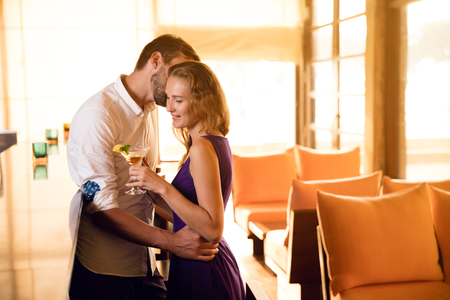 young couple drink cocktails in hotel barの写真素材
