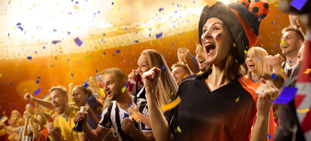 stadium soccer fans emotions portrait in yellow toningの写真素材