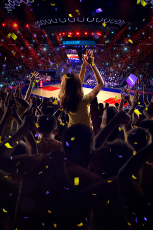 Fans on basketball court in game Confetti and tinselの写真素材