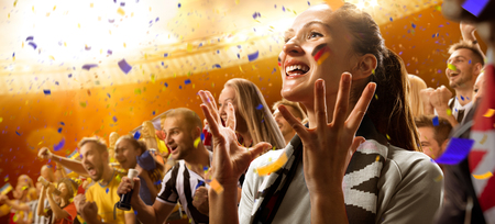 stadium soccer fans emotions portrait in yellow toningの写真素材