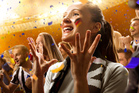 stadium soccer fans emotions portrait in yellow toningの写真素材