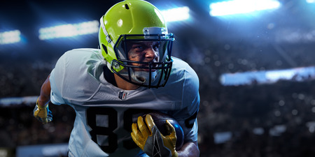American football sportsman player on stadium in action. Sport wallpaper or advertisingの写真素材