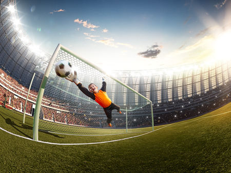 gatekeeper children soccer player in action. stadiumの写真素材
