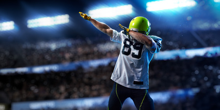 American football sportsman player on stadium in action. Sport wallpaper or advertisingの写真素材