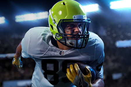 American football sportsman player on stadium in action. Sport wallpaper or advertisingの写真素材