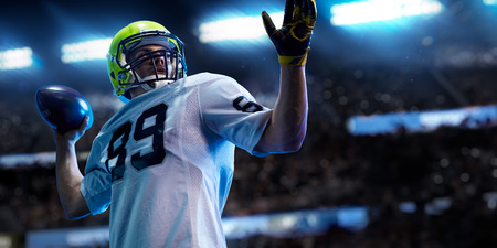 American football sportsman player on stadium in action. Sport wallpaper or advertisingの写真素材