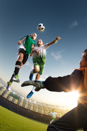children soccer player in action in stadiumの写真素材