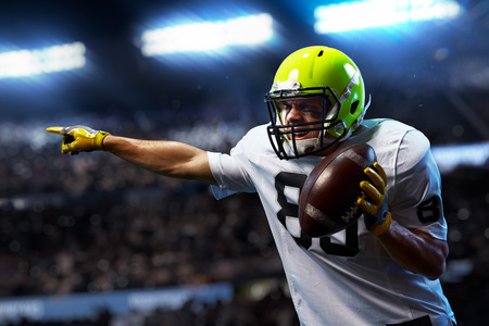 American football sportsman player on stadium in action. Sport wallpaper or advertisingの写真素材