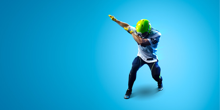 American football sportsman player on blue gradient background. Sport wallpaper or advertisingの写真素材