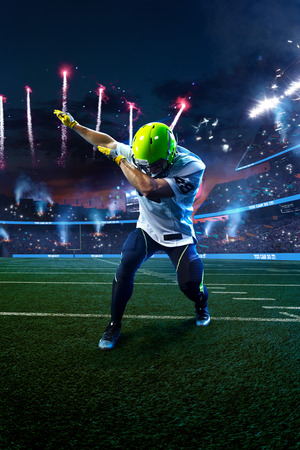 American football player celebrate tocuhdown on stadium. Sport wallpaper or advertisingの写真素材
