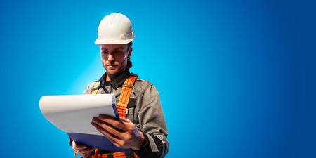 Windmill engineer planing new ecology project. He standing and look in tablet. Color studio backgroundの写真素材