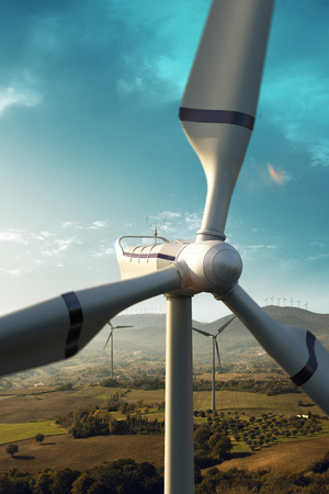 Happy engineer feel success after good work. He standing a top of windmill and looking beautiful sunset landscapeの写真素材