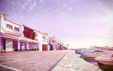 Shopping street near luxury boat. sunny day empty street. kozy pink color toneの写真素材