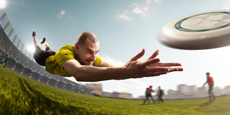 player play ultimate flying disc in stadium. Around beautiful sunny dayの写真素材