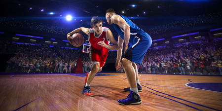 Basketball player n action. around Arena with blue light spotの写真素材