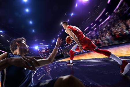 Basketball player make block shot in jump. around Arena with blue light spotの写真素材