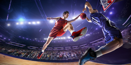Basketball player make block shot in jump. around Arena with blue light spotの写真素材