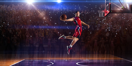 Basketball player in jump. around Arena with blue light spotの写真素材
