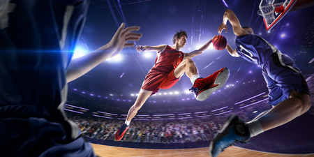 Basketball player make block shot in jump. around Arena with blue light spotの写真素材