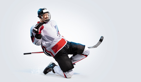Hockey player isolated in white background celebrate winの写真素材