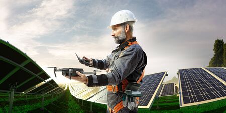 Solar energy engineer using drone for check stationの写真素材