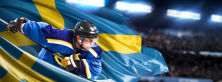 Sweden Hockey Player in action around national flagsの写真素材
