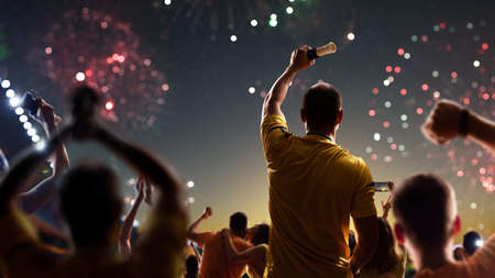 Fans celebrate in Stadium Arena night fireworksの写真素材