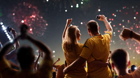 Fans celebrate in Stadium Arena night fireworksの写真素材